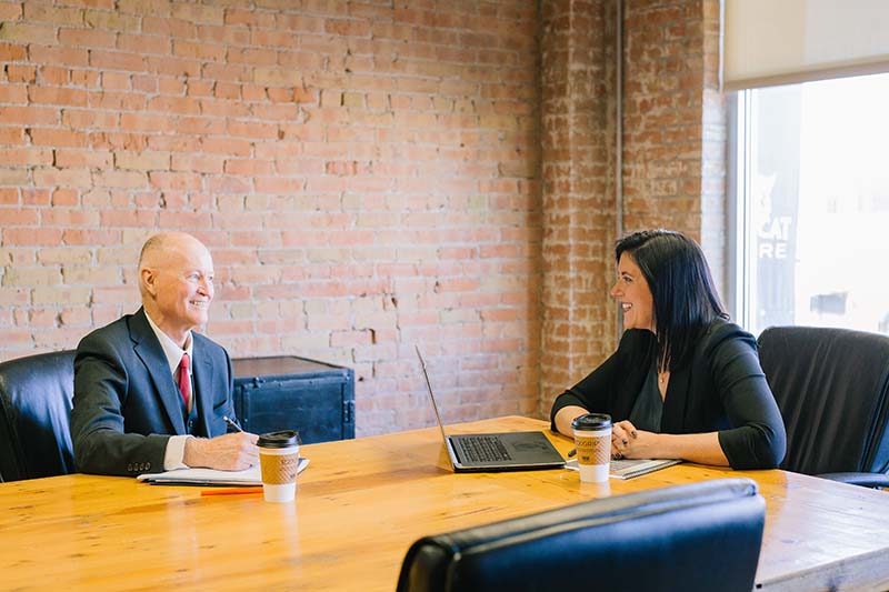 A photo of two person having a conversation.