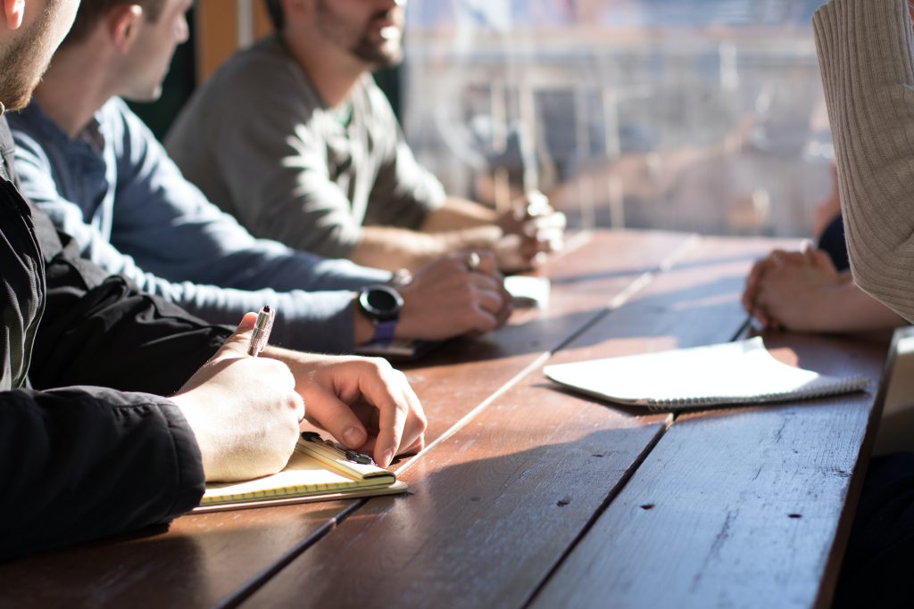 A photo of group of people having a conversation.